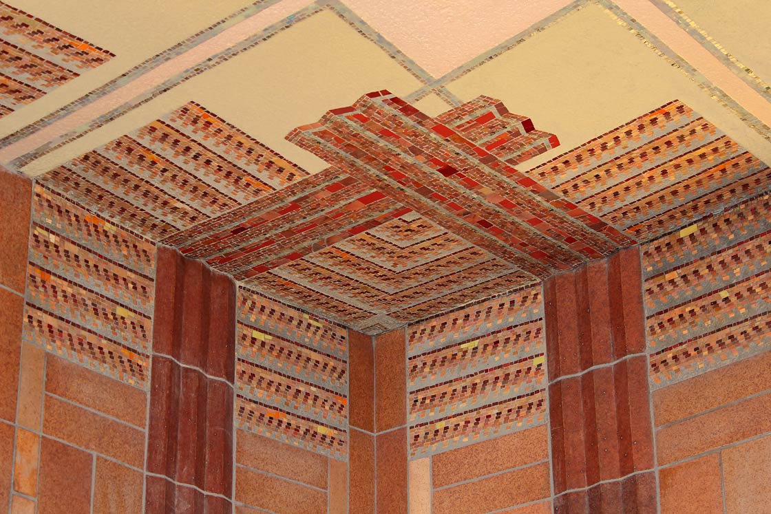 Detail of border design in lobby corner in silhouette mosaic and colored plaster